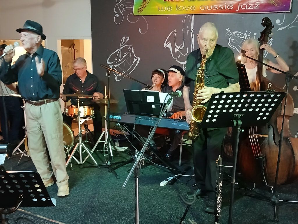 The Early Birds, with a singer in a hat and a saxophonist
