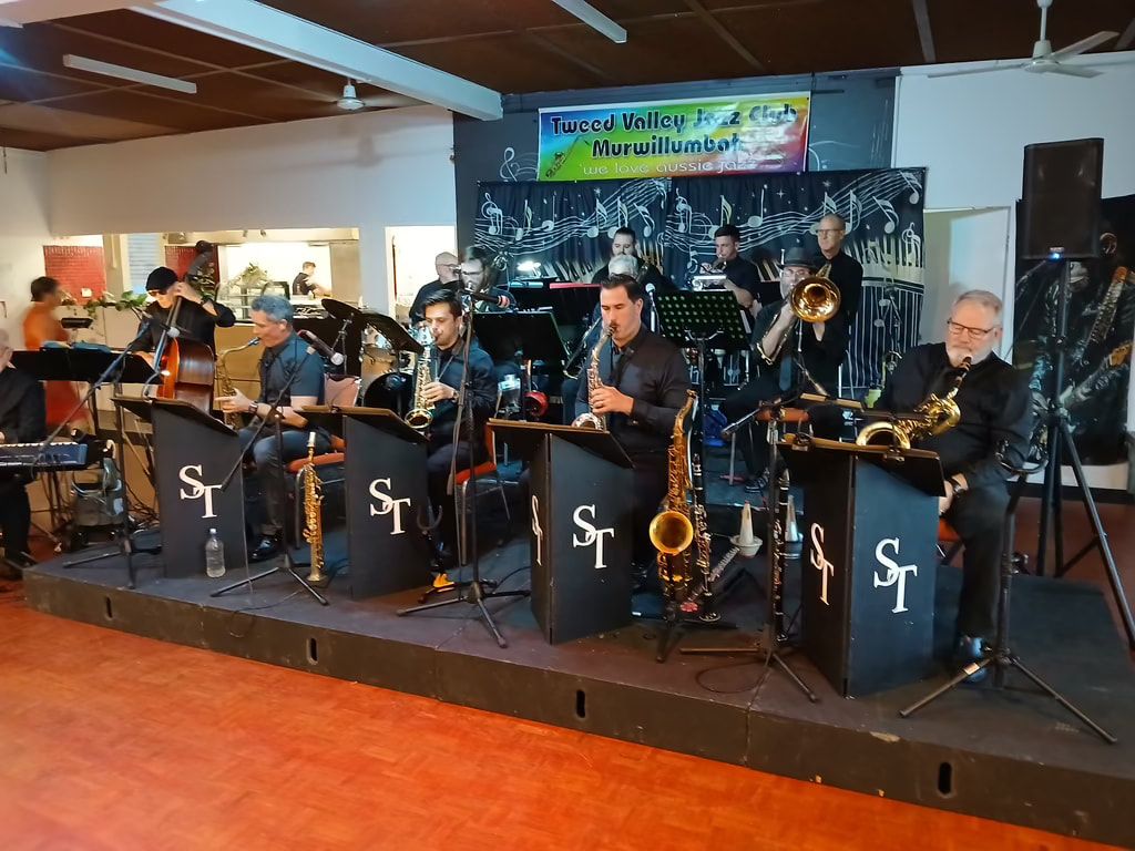 Sweet Thunder big band seated behind their ST music stands