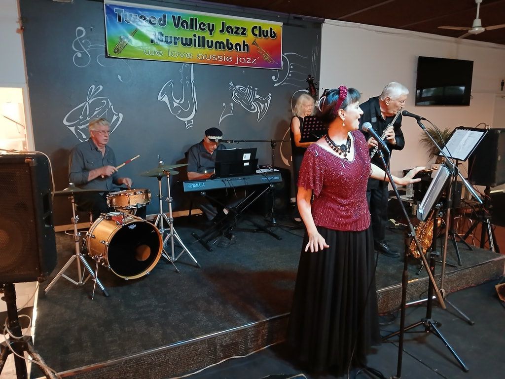 The Early Birds, with a singer in a red top and long black skirt