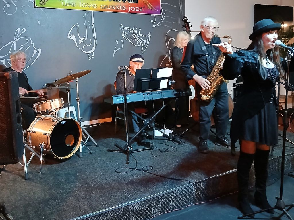The Early Birds' singer in a black hat, with sax, keyboard and drums